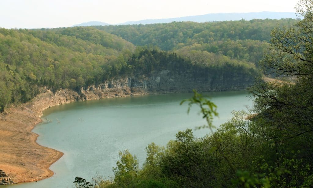 A lake in the middle of a wooded area, offering Kentucky Park and camping options.