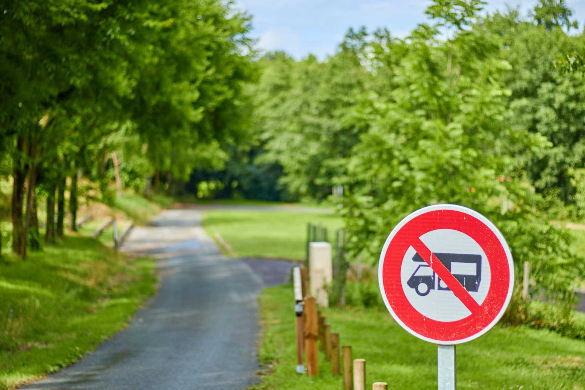 A "RV Ban" sign on the side of a road in a California town.