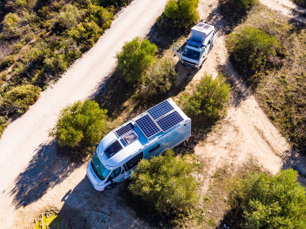 A truck with a van on the side and solar panels, which can be used as an RV for adventures in Wyoming.