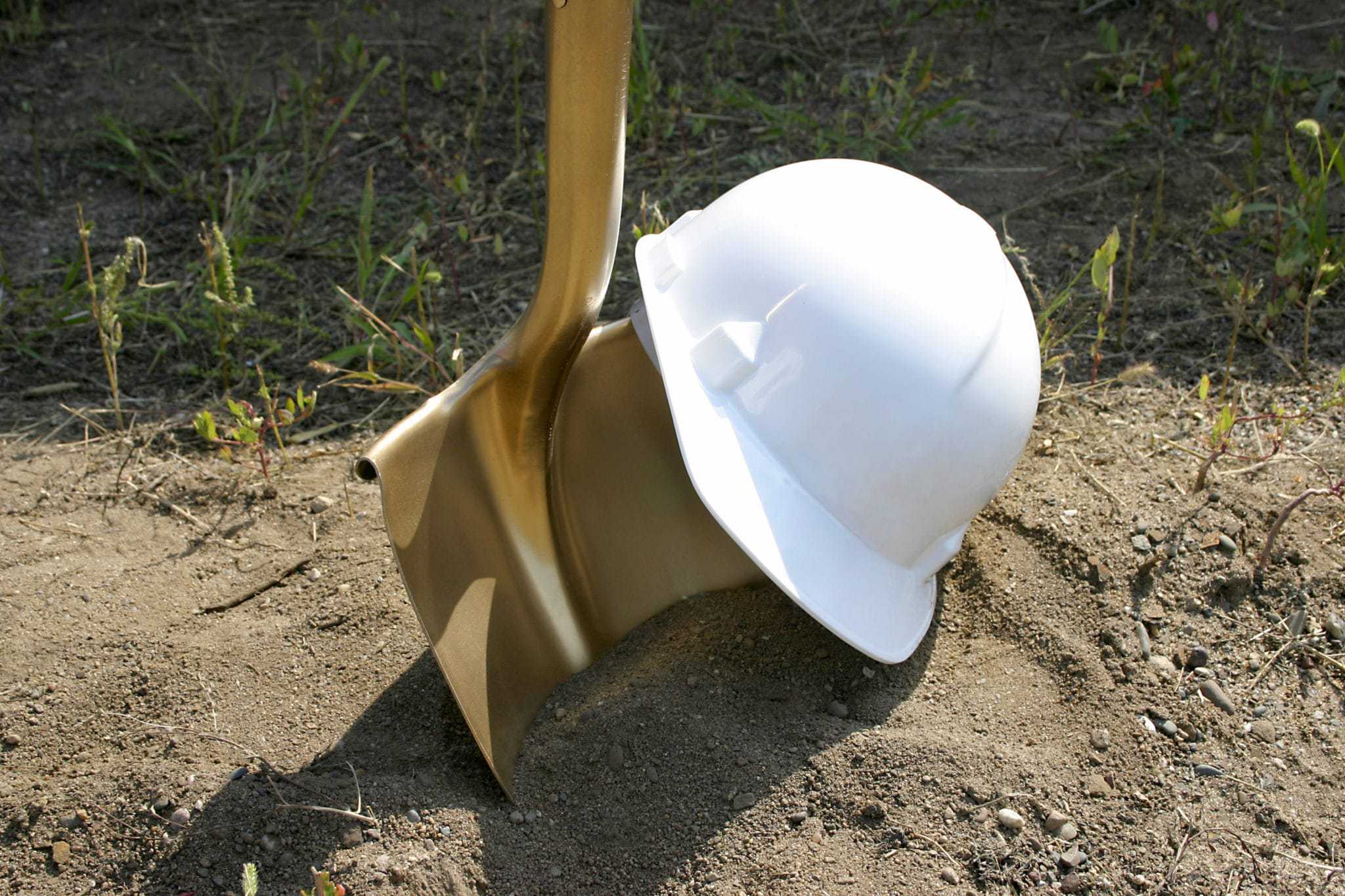 A white hard hat digs into the dirt at a campground in the San Francisco Bay area park.