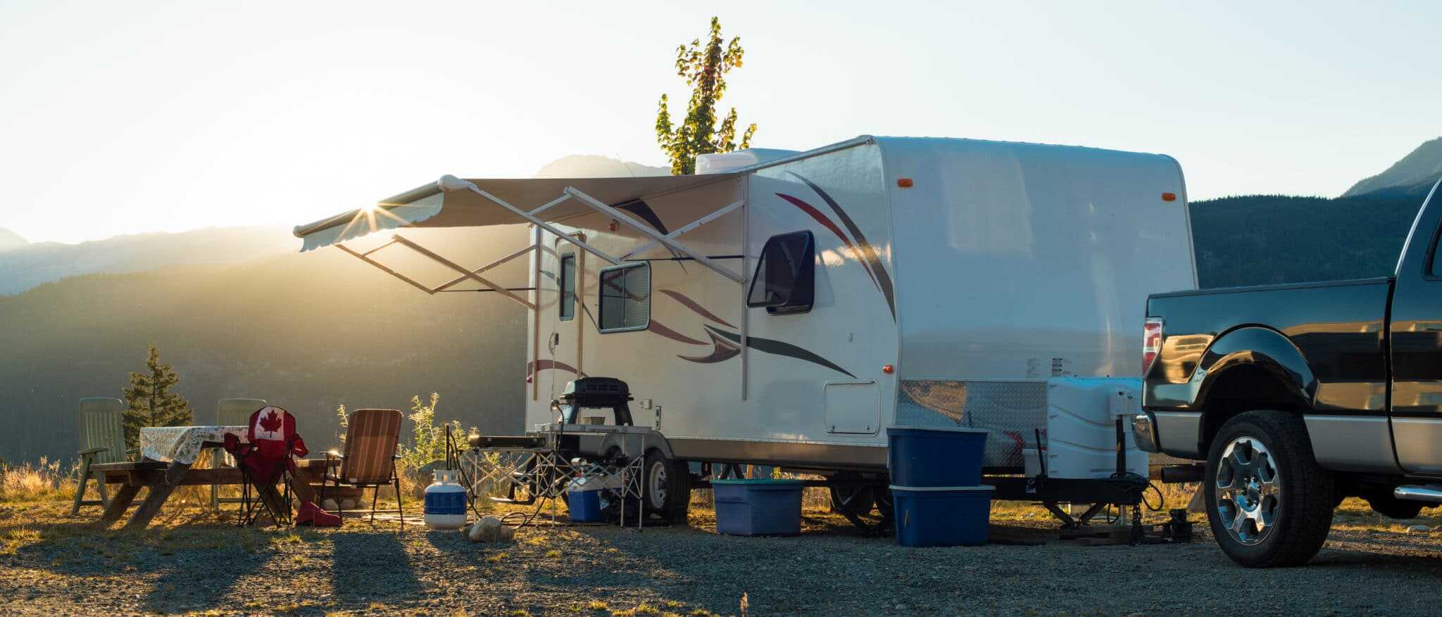 A white trailer with a canopy, perfect for camping during the pandemic.