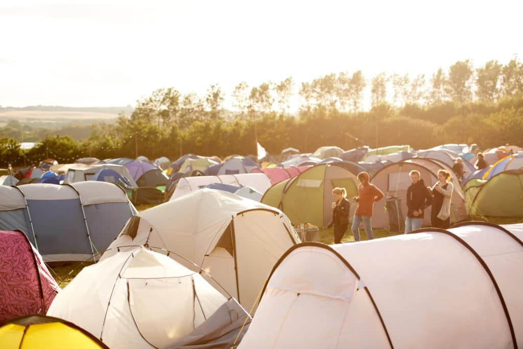 A large group of tents in a field.