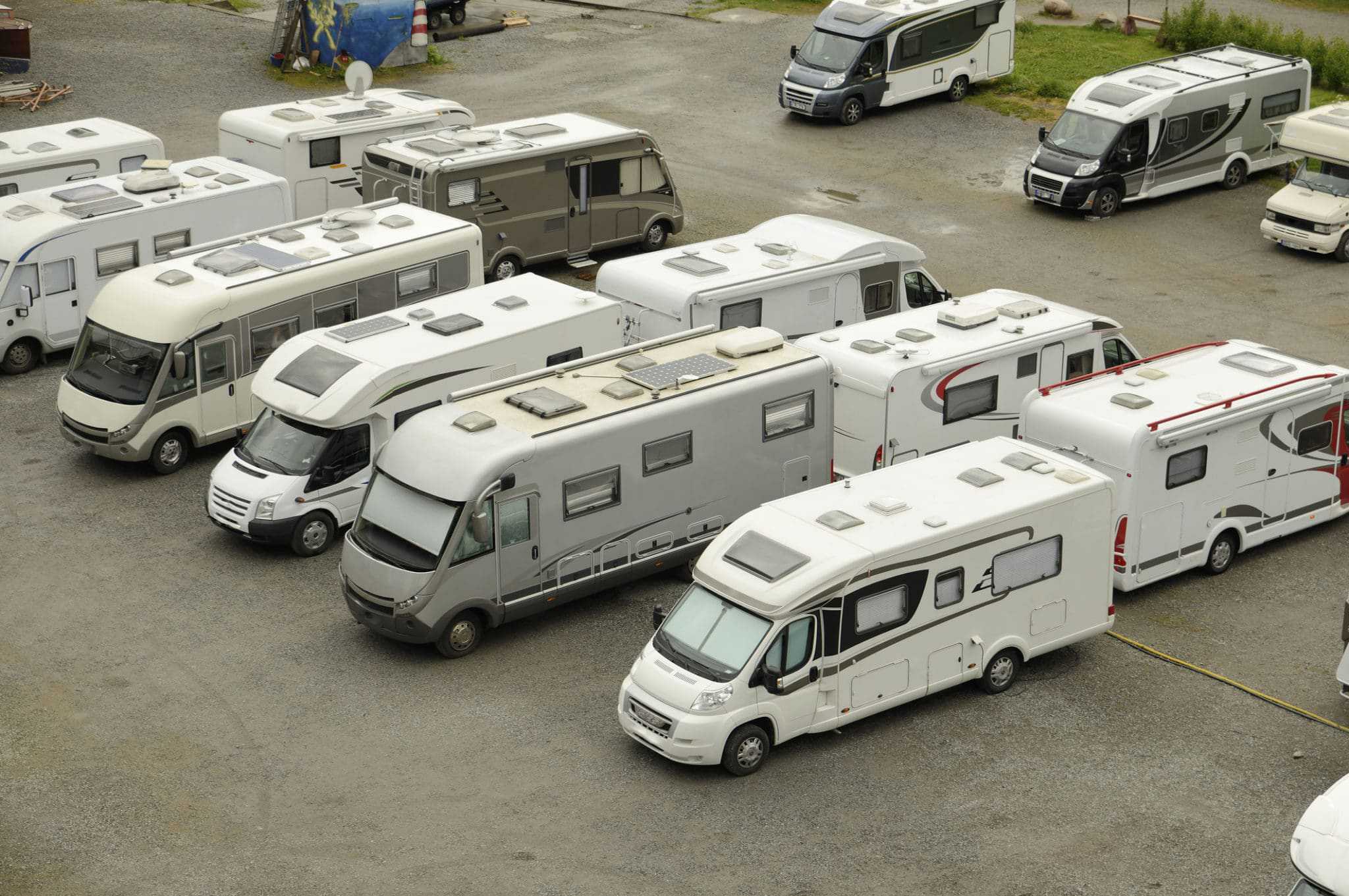 Many Montana RVs are parked in a trailer parking lot.