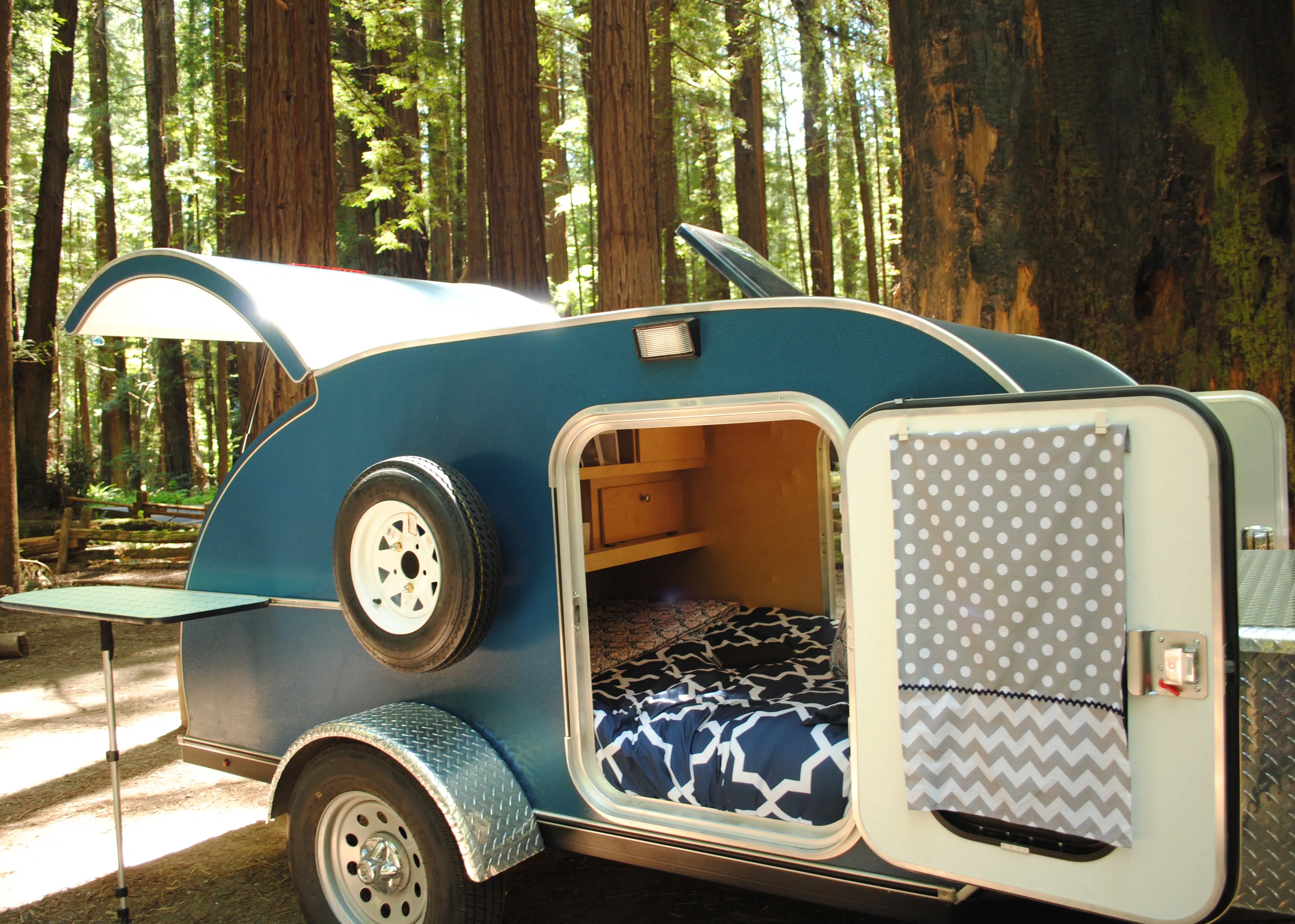 A retro travel trailer in California's woods.