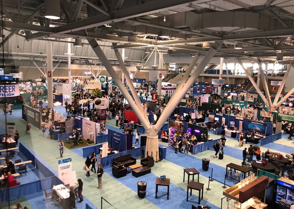 An aerial view of a convention hall with many people at the RV Dealers Convention/Expo.