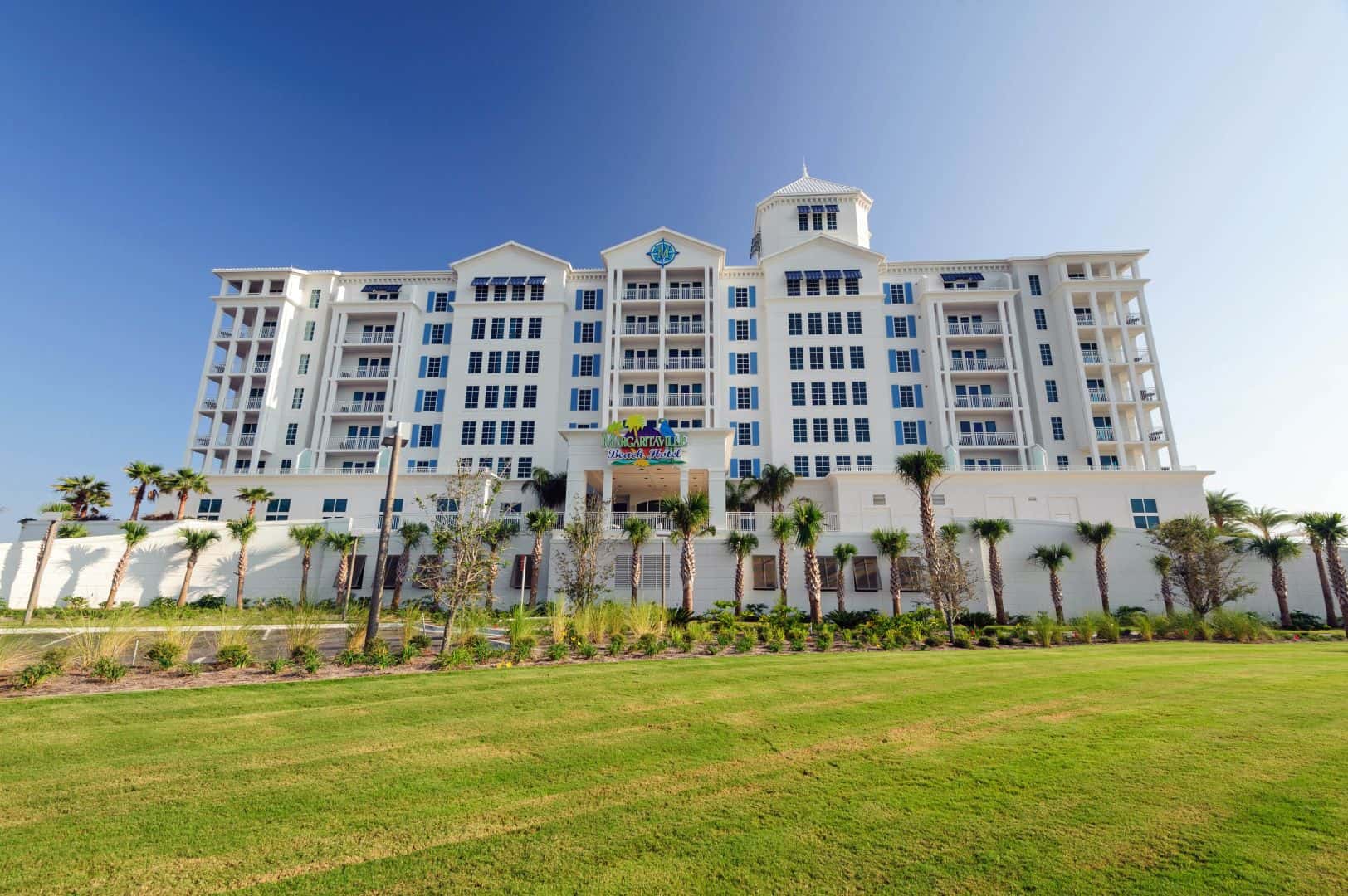 A large white building with palm trees in front of it, reminiscent of a tropical paradise at Margaritaville