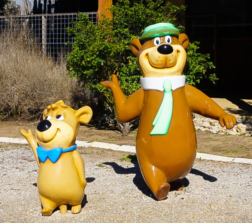 A bear statue and a teddy bear figurine.