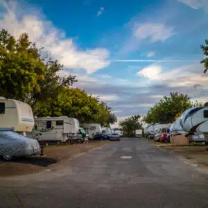 A group of rvs parked in a parking lot.