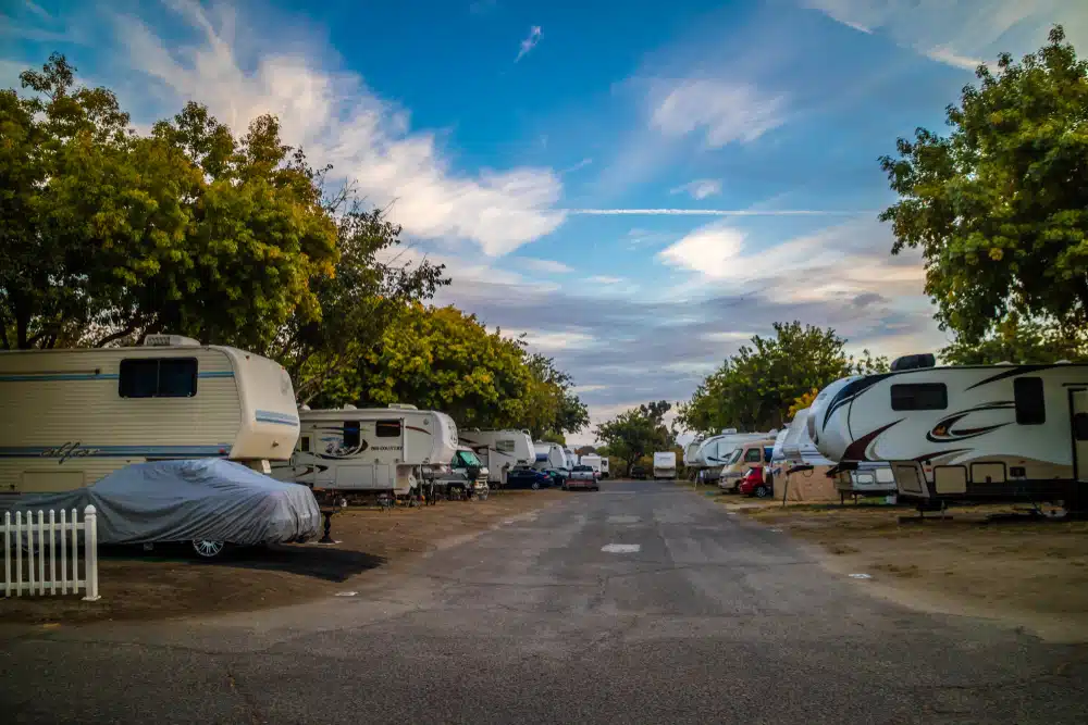 A group of rvs parked in a parking lot.