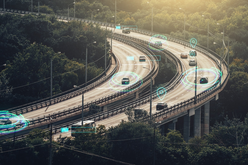 A highway with cars equipped with Asset Tracking Technology that acquires an advantage by being connected to the internet.