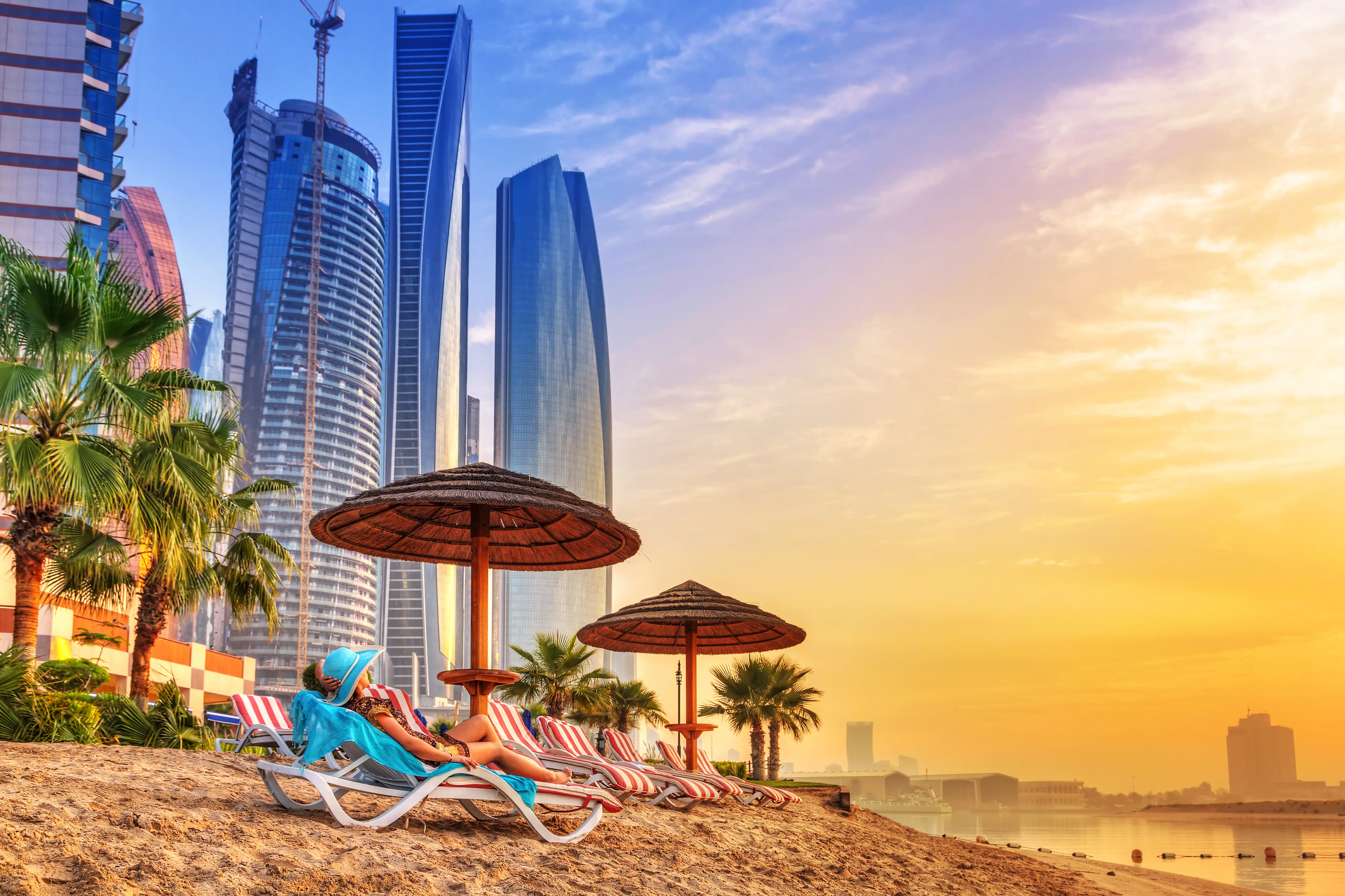 Glampers relax on the beach at sunset in Dubai.