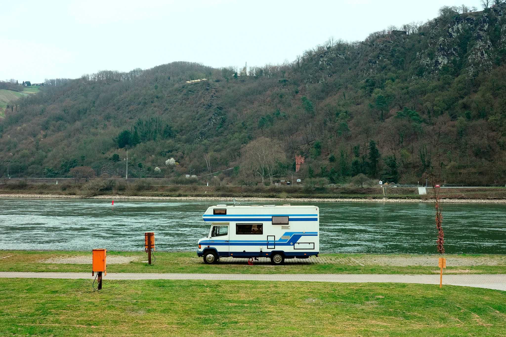An Eberspächer rv parked on the side of a river.