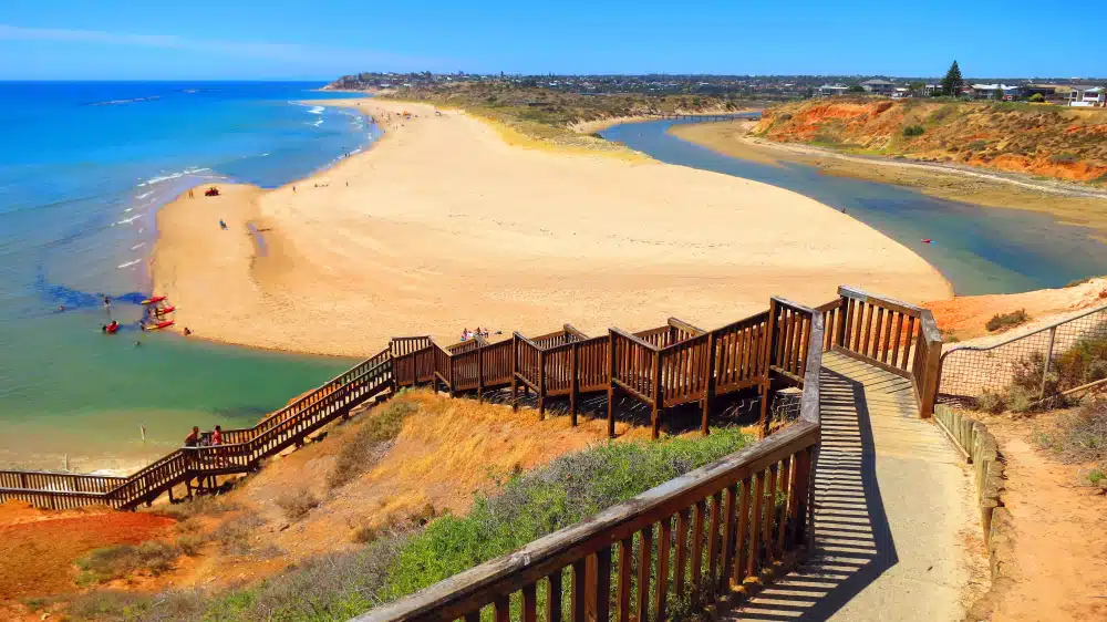 A wooden stairway leading to a sandy beach in Australia.