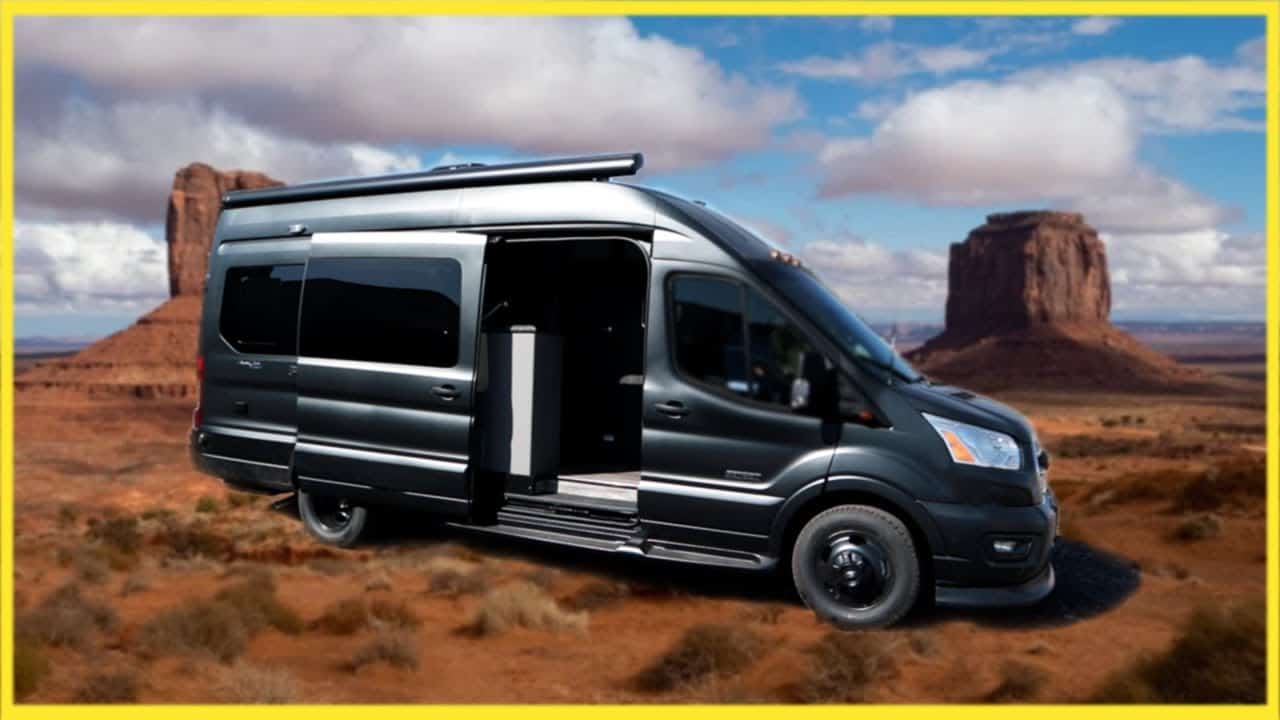 The luxury Ford Transit camper van is parked in front of a desert.