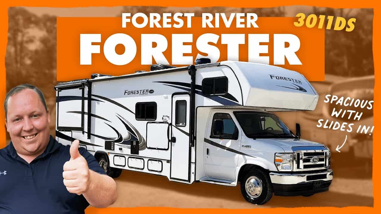 A man is giving a thumbs up in front of a spacious Class C Forester RV.