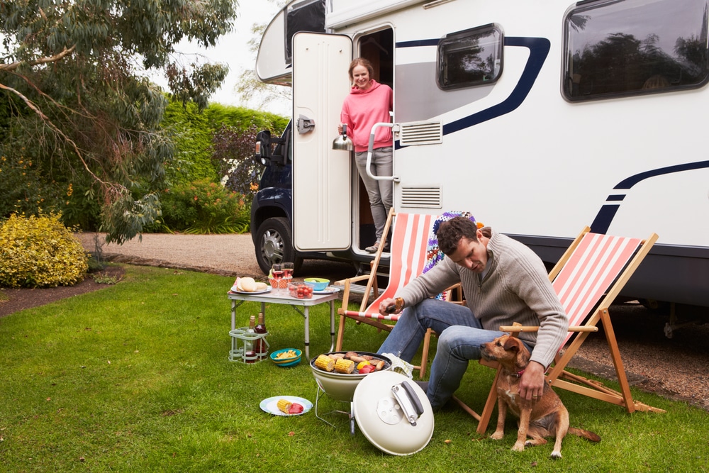 A man and woman sitting in lawn chairs next to an RV during LCI Industries' Third-Quarter 2021 Conference Call.