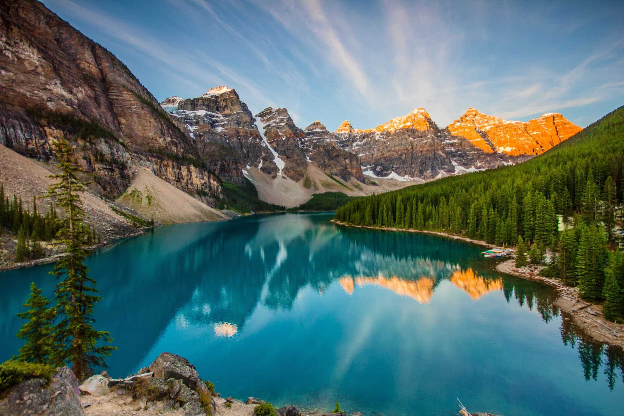 A lake surrounded by mountains at sunrise in Banff National Park, Canada, known for its breathtaking BCLCA views.