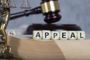 A Forest Heights Campground Appeal is visually depicted on a book with a gavel resting atop, symbolizing the decision-making authority of the Board as it considers the case related to Alberta County.