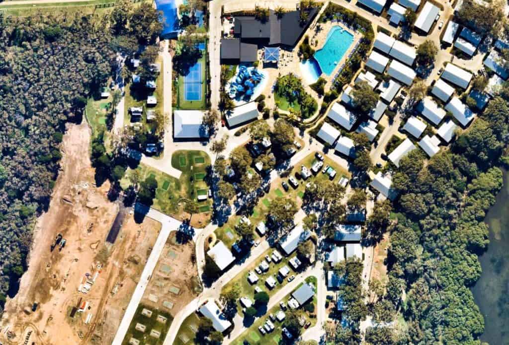 People enjoying a holiday resort from an aerial view, surrounded by nature and embracing the joy of camping.