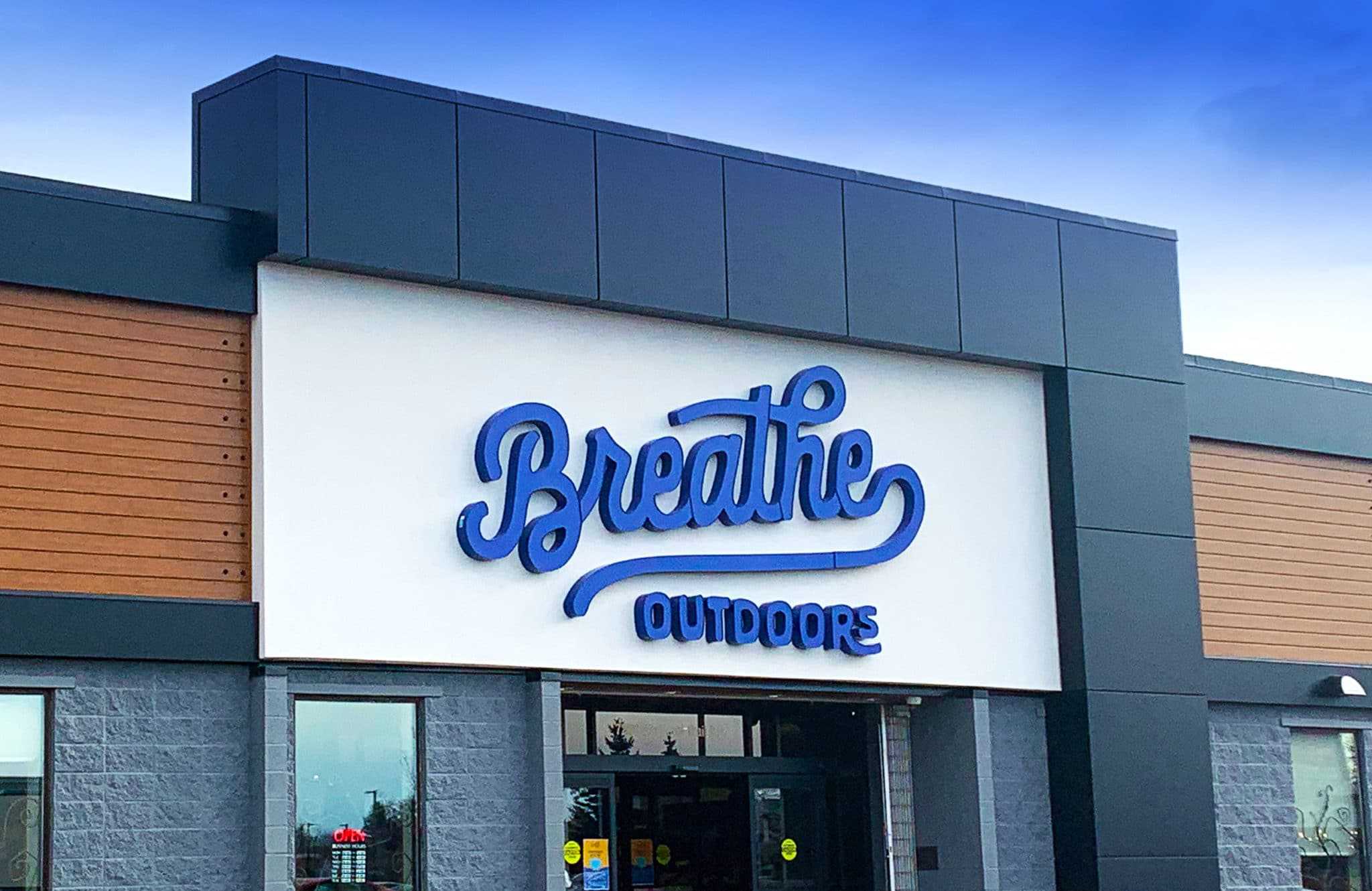 A new brand building with a sign that says breathe outside.