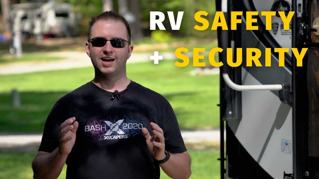 A man in sunglasses is standing next to an RV with the words "RV safety" and "security" prominently displayed.