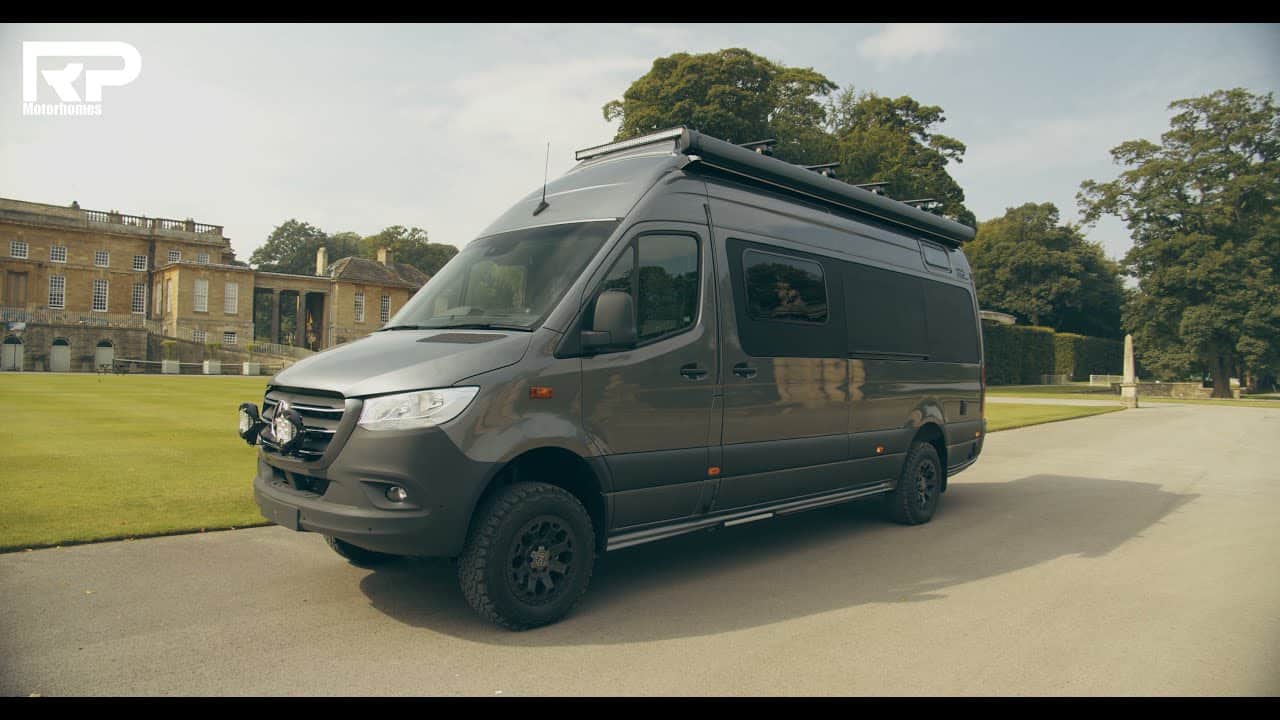 The Ultimate Mercedes Sprinter, fully-equipped for any expedition, is parked in front of a mansion.