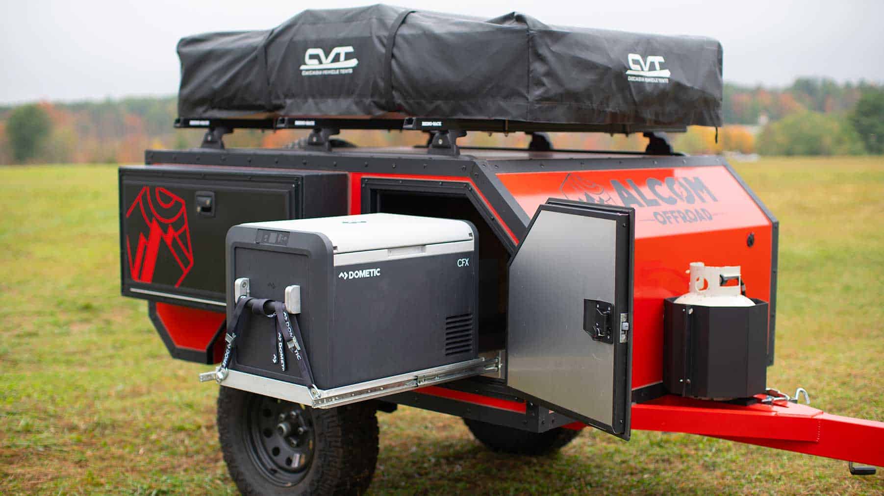 A Triton Trailers camper trailer with a built-in cooler on it.