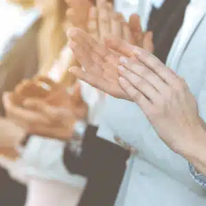 A group of business people clapping their hands.