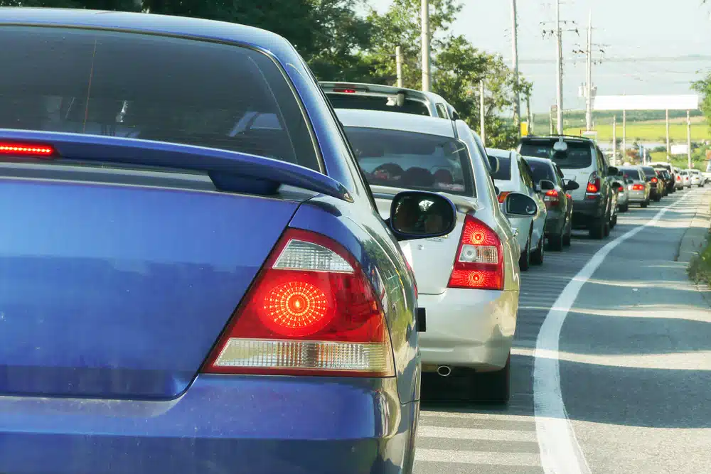 A blue car stuck in Thanksgiving traffic.