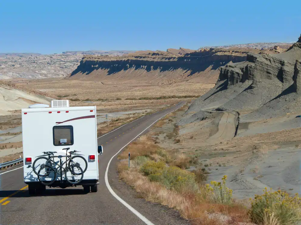 Morgan Larkin, the Chief Operating Officer at RVshare, oversees a fleet of RVs traveling down a road.