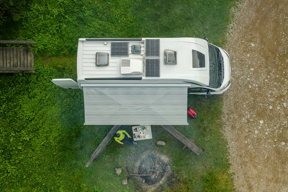 An aerial view of a camper with a fire pit showcased at METSTRADE 2021.