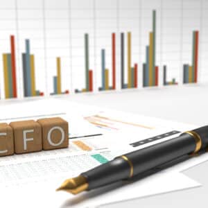 The word CFO on top of a pen and graphs, featuring Carlos Navarro as the Chief Finance Officer.