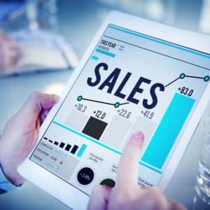 A person holding a tablet displaying the third quarter sales graph, which reveals a record-breaking performance for the Shyft Group.