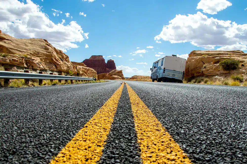 As part of the bipartisan infrastructure deal, an RV representing American mobility ventures down a road in the desert.