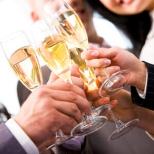 A group of people toasting with wine glasses.