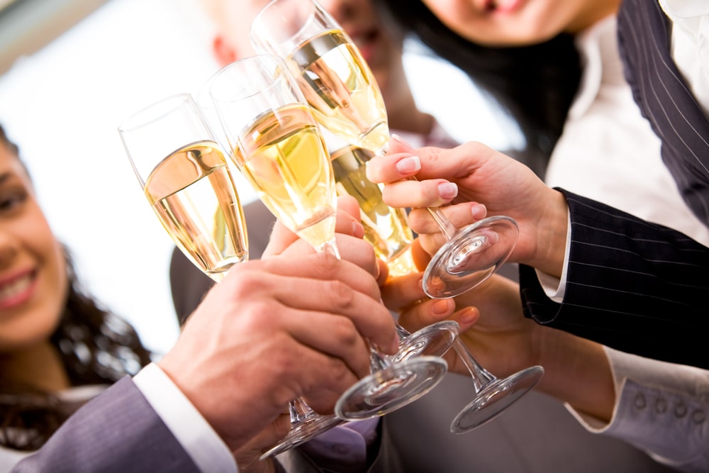 A group of people toasting with wine glasses.