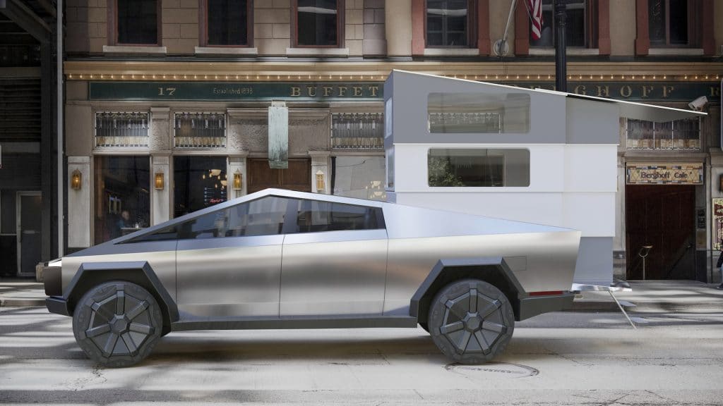 A silver CyberLandr vehicle is parked in front of a building.