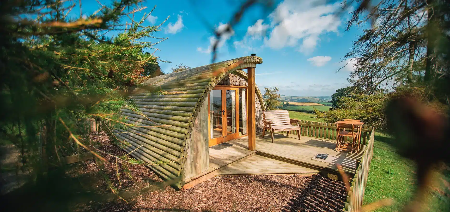 The Best wooden cabin sits on top of a hill in Powys, offering a Luxury Glamping Site experience.