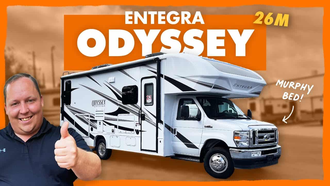 An rv with the words entera odyssey and a man giving a thumbs up. The awesome Murphy Bed adds versatility, while maintaining the compact size of this miniature Class C motorhome.