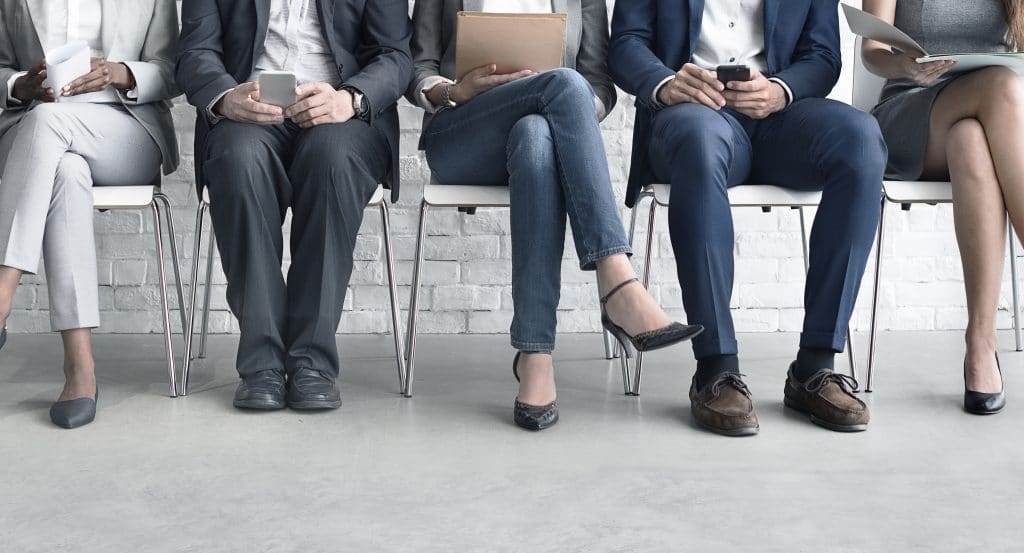 A group of business people sitting in a row.