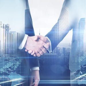 Two businessmen shaking hands in front of a city background, overseeing the acquisition of land for outdoor recreational opportunities and camping.