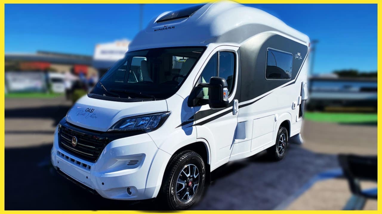 A tiny Euro-Style camper van is parked in a parking lot.