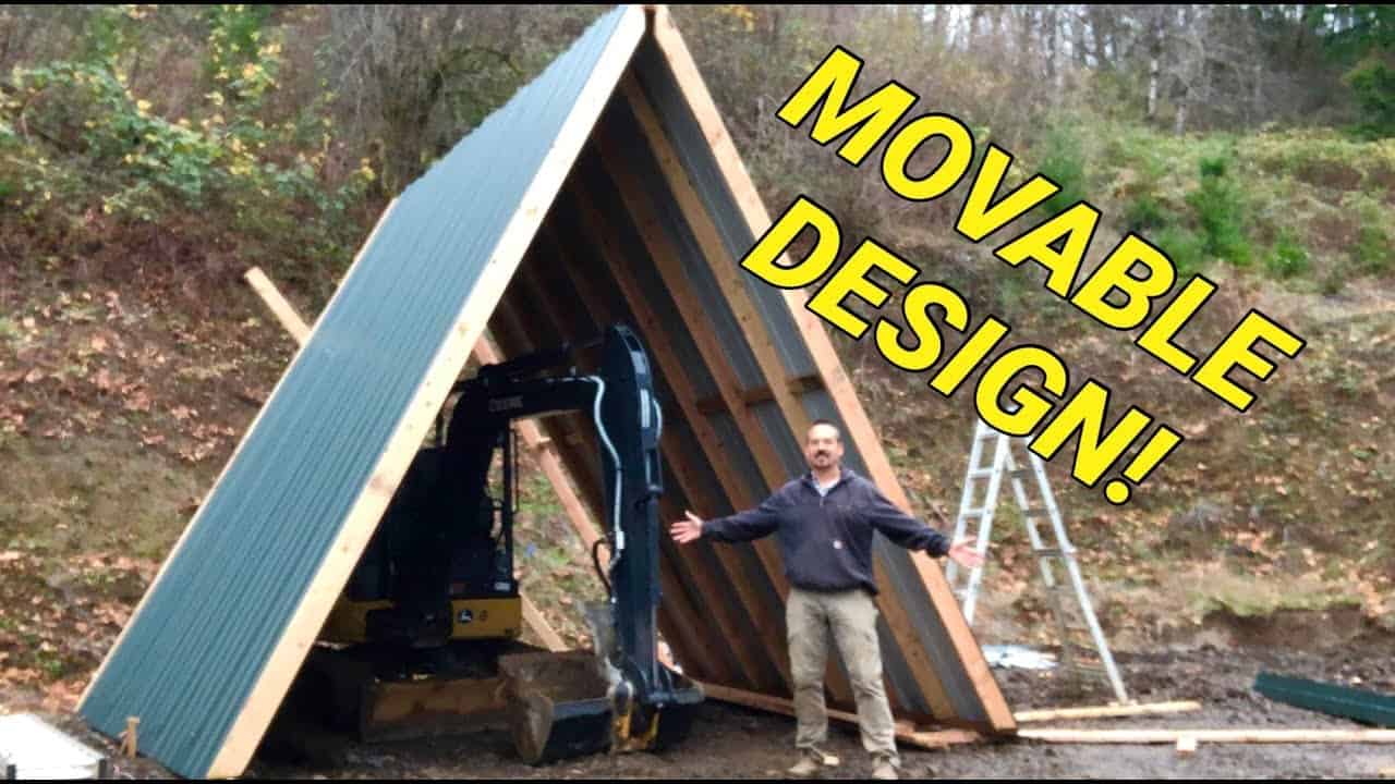 A man standing in front of a moveable design building with the words Storage Shed.