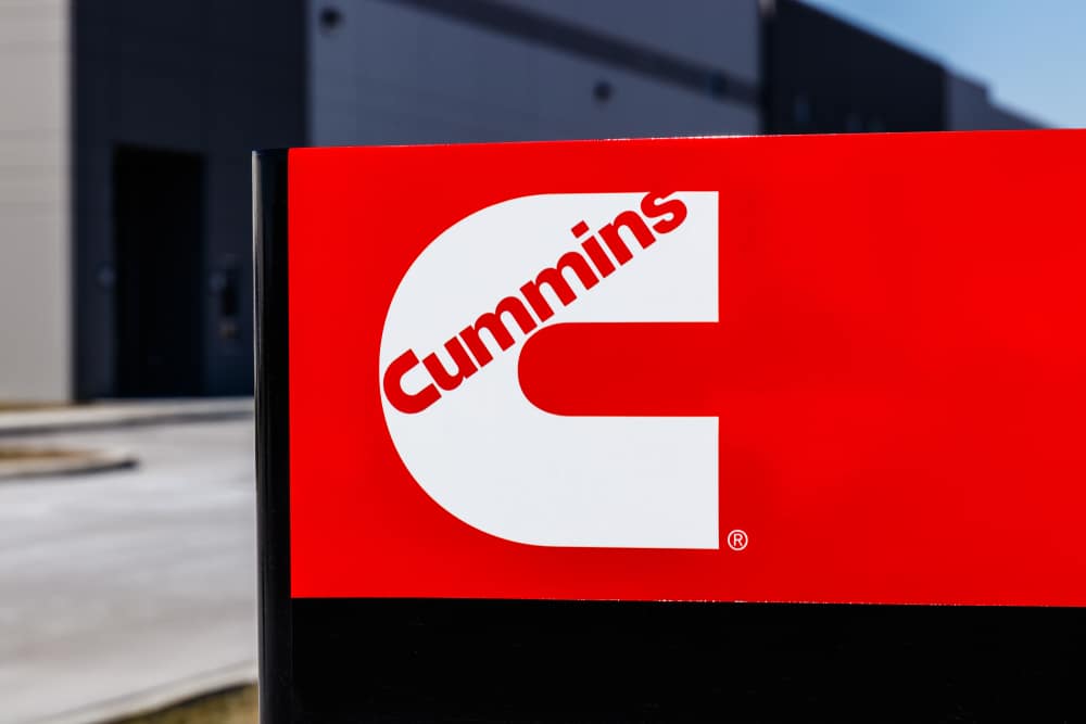 A red cummins sign in front of a building.