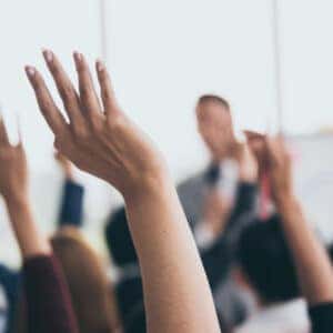 Residents of Tremont raising their hands in a meeting at the Campgrounds.