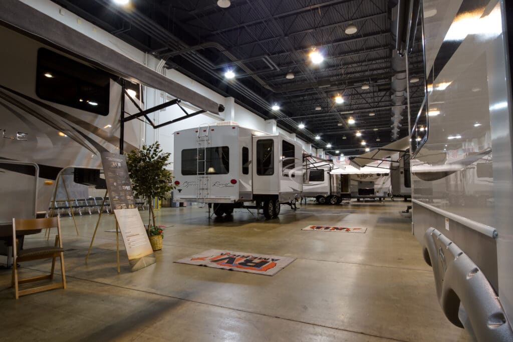 An rv showroom with many rvs in it.