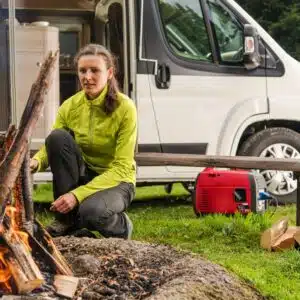 A Grass Valley resident is preparing a campfire in front of an RV.