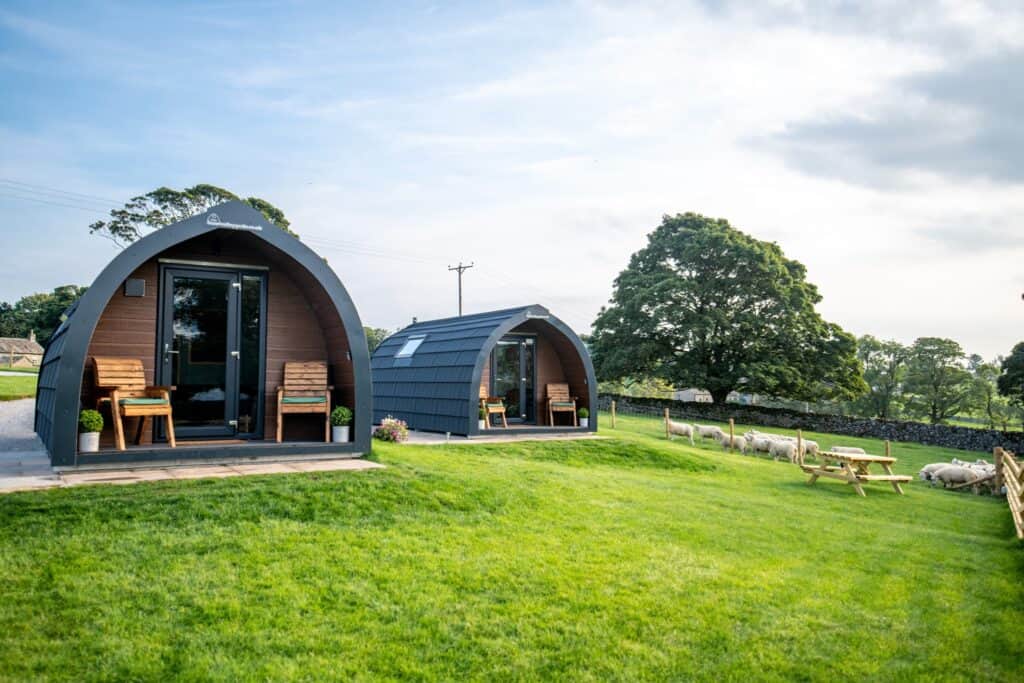 Two small cabins in the farm fields of Yorkshire Dales National Park.
