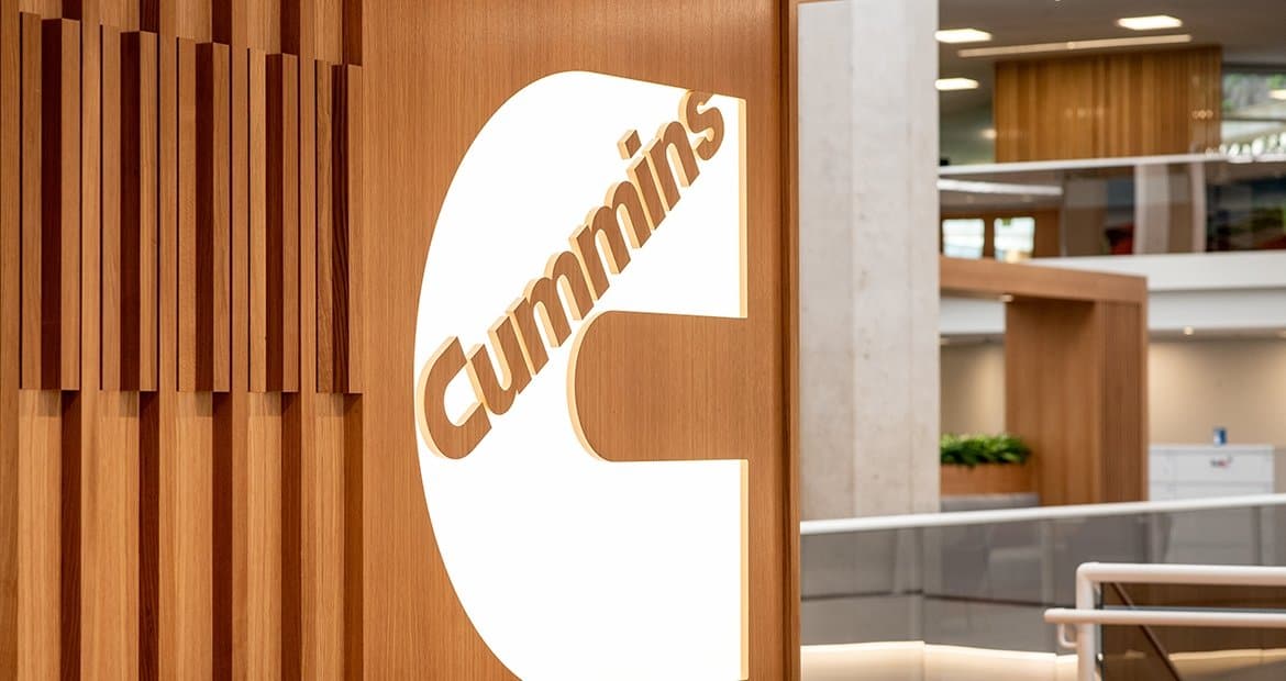 A wooden sign with the word Cummins on it.