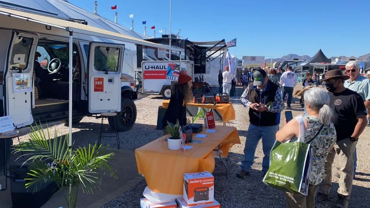 A group of people at the Quartzsite RV Show standing around a table showcasing Jackery's Solar Energy Solutions.